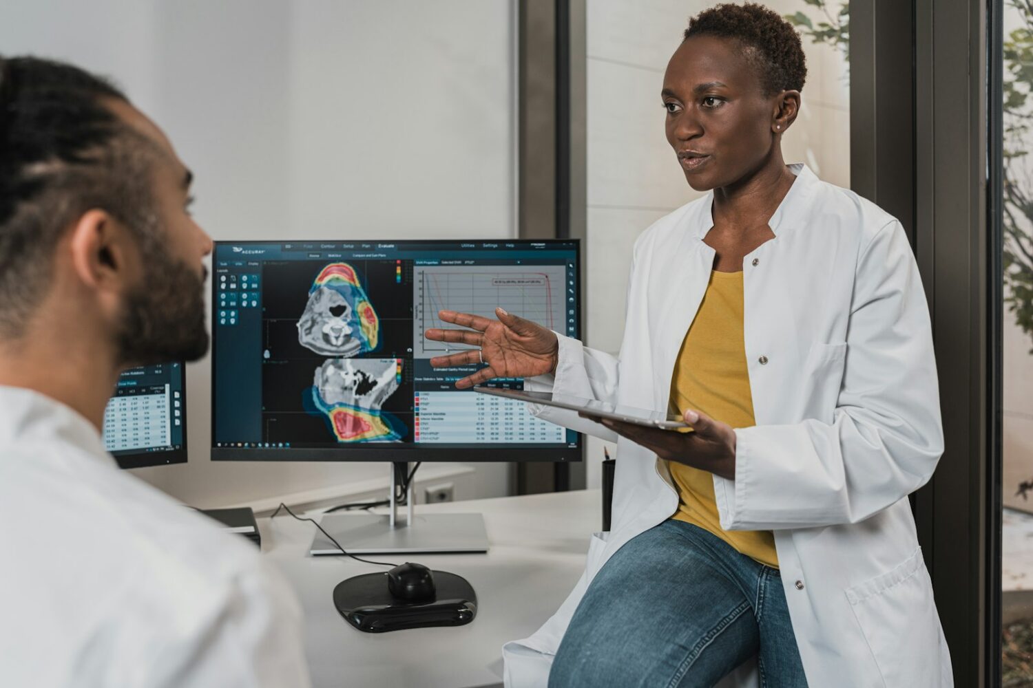 Two clinicians reviewing results together on a monitor