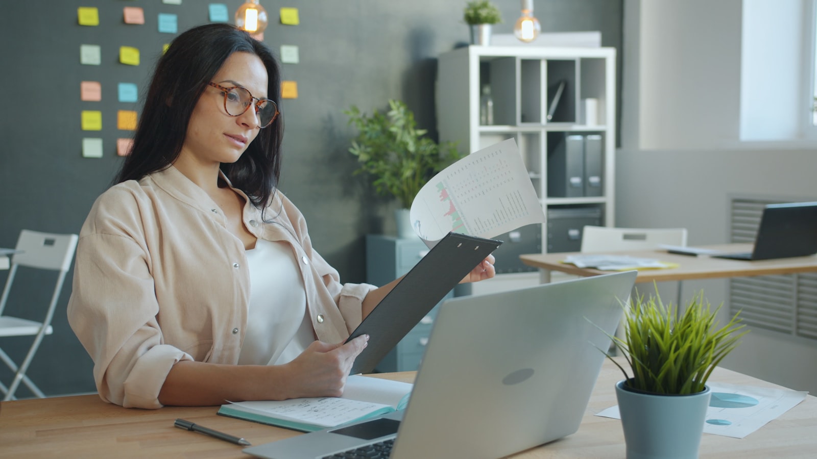 A practice manager at her desk reviewing a printed report